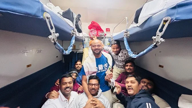 Trip Buddies travellers sharing a group moment in a train carriage