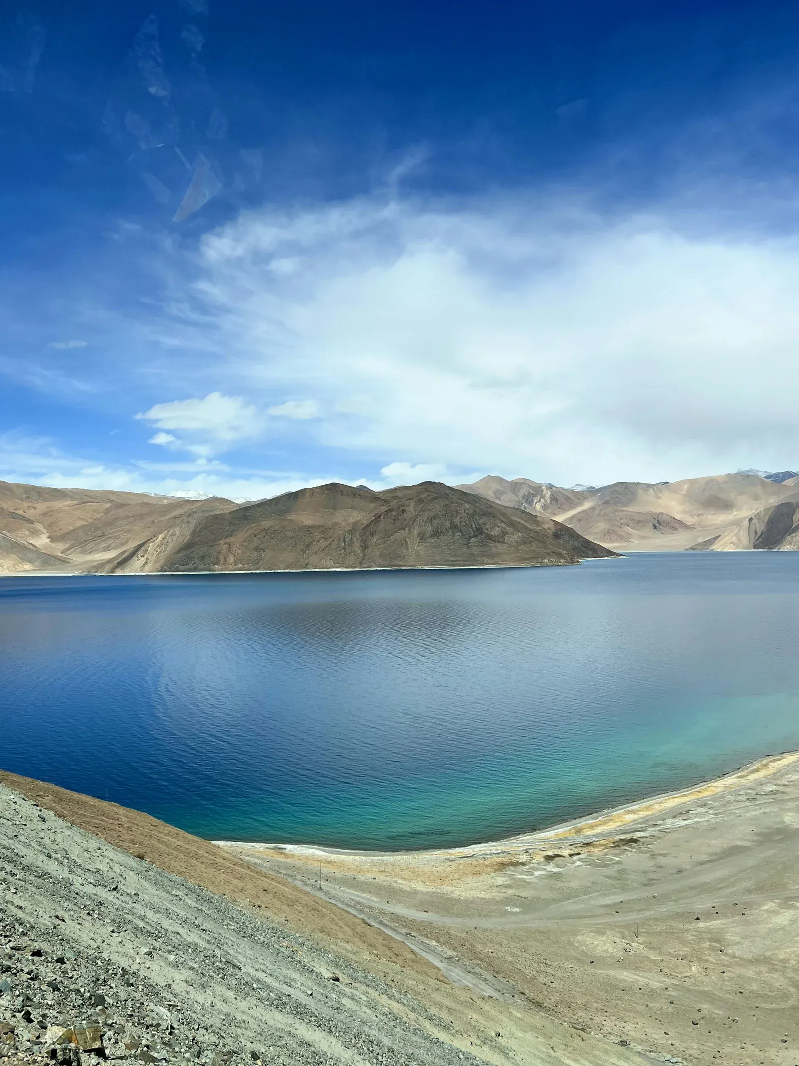 Blue water and mountain reflections at Pangong Lake